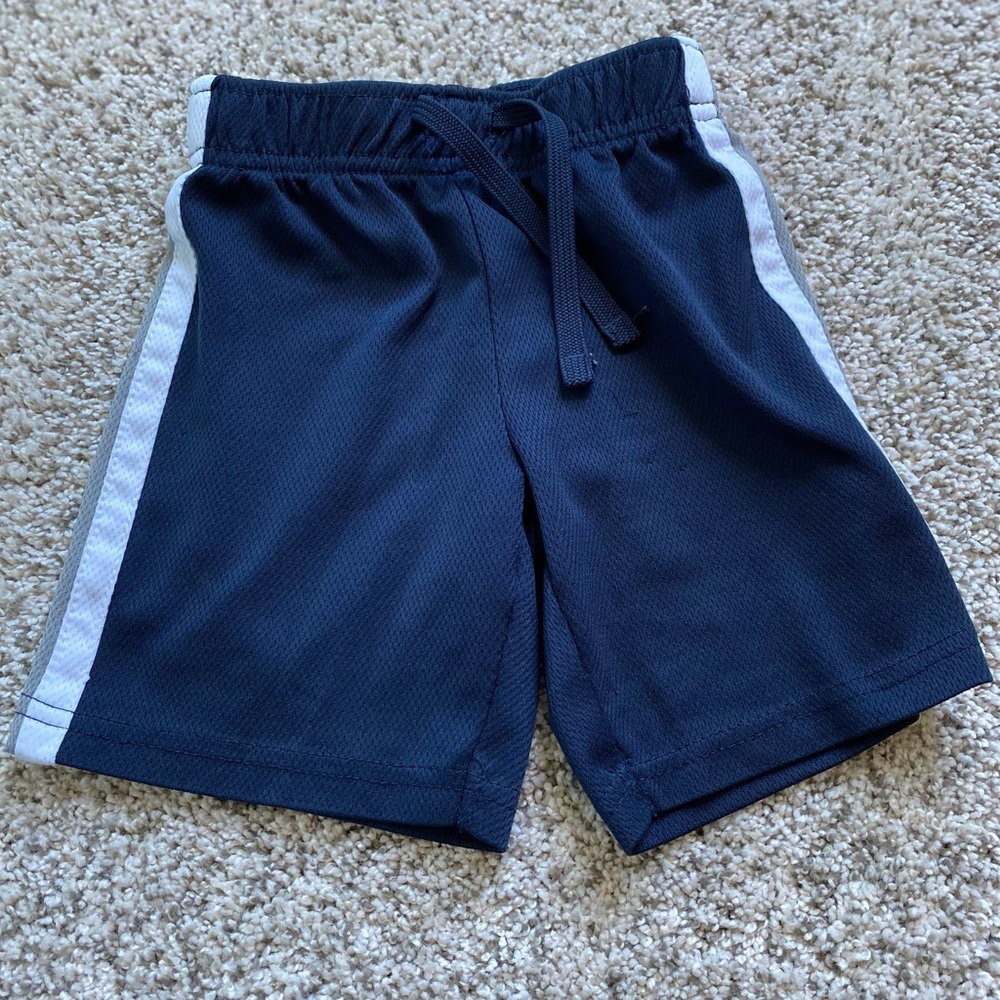 Old Navy blue mesh shorts. White/gray line on sides. Tie in front. Boys size 2T.